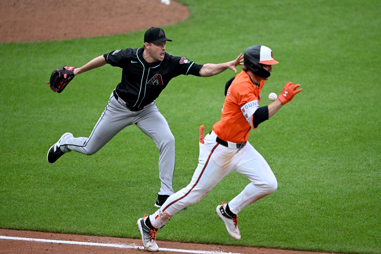 Joe Mantiply throws ball to first base.