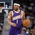 Phoenix Suns guard Devin Booker (1) moves the ball against the Los Angeles Lakers during the first half at Acrisure Arena.