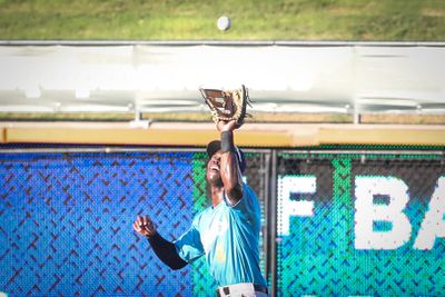 Kristian Robinson prepares to catch a fly ball, squinting against the sun during a day game in Corpus Christi on August 1. Syndication: The Corpus Christi Caller Times