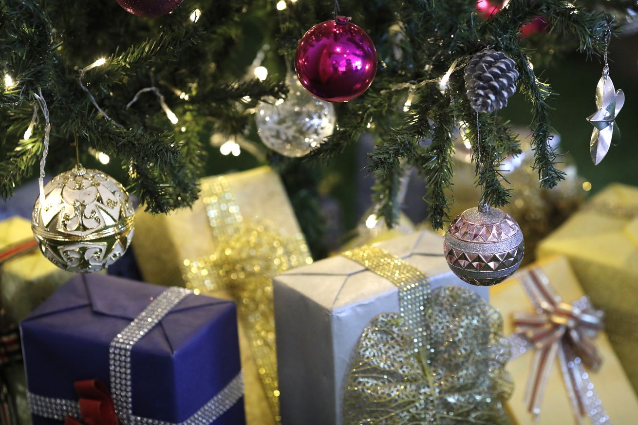 Group of Christmas presents under a decorated tree. Ho Chi Minh City. Vietnam