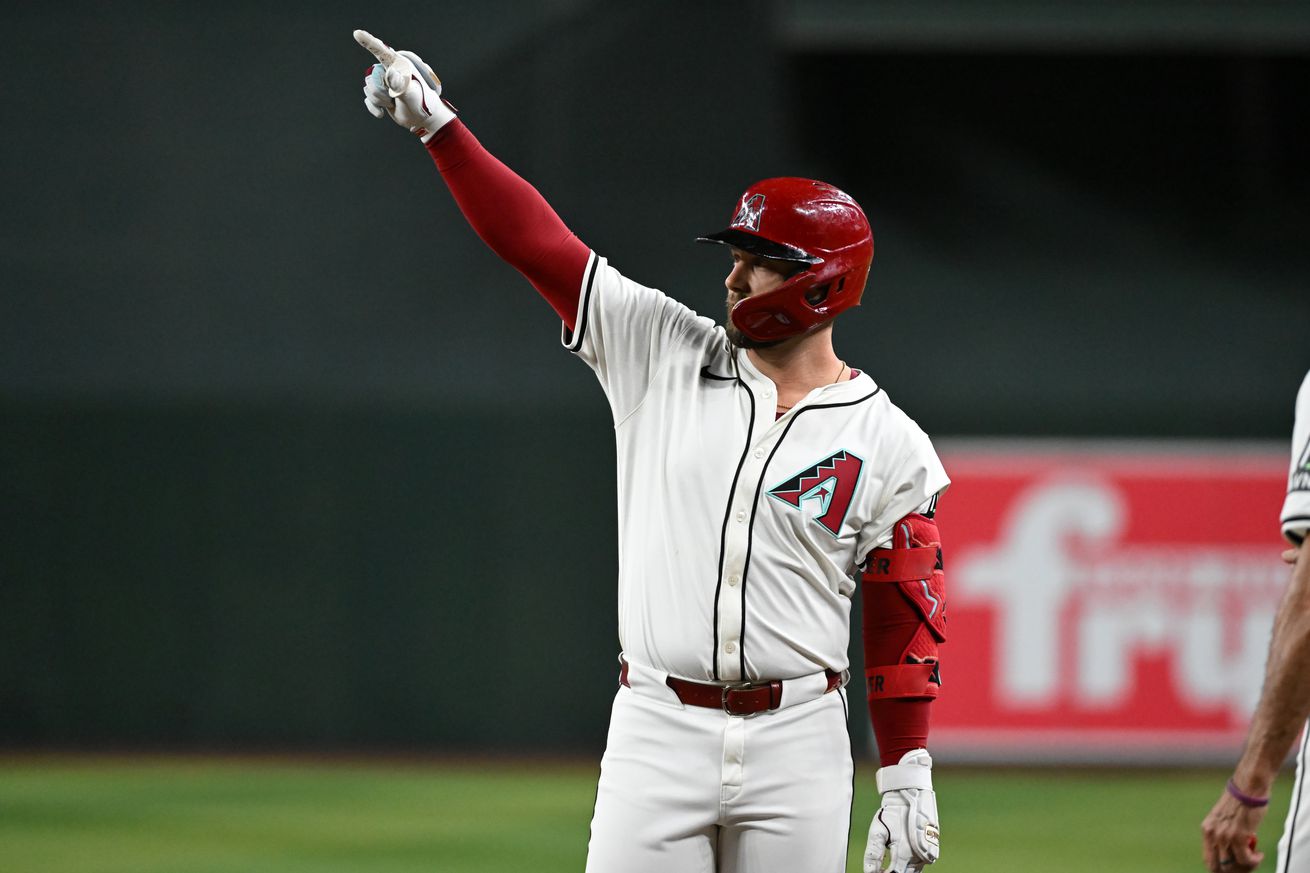 Walker points towards the dugout after hitting an RBI single at Chase Field