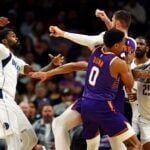 Dallas Mavericks forward Naji Marshall (13) punches Phoenix Suns center Jusuf Nurkic (20)