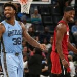 Miami Heat forward Jimmy Butler and Memphis Grizzlies guard Marcus Smart share a laugh