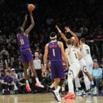 Phoenix Suns fan favorite Bol Bol shoots over the top of the Denver Nuggets defense